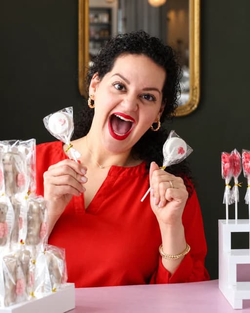 Elizabeth Girgis, baker and founder of Lotus Sweet Treats, holding a box of cake pops