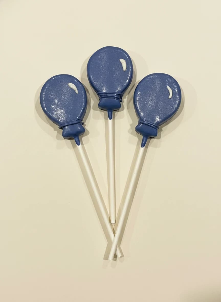 Blue balloon-shaped cake pops by Lotus Sweet Treats.